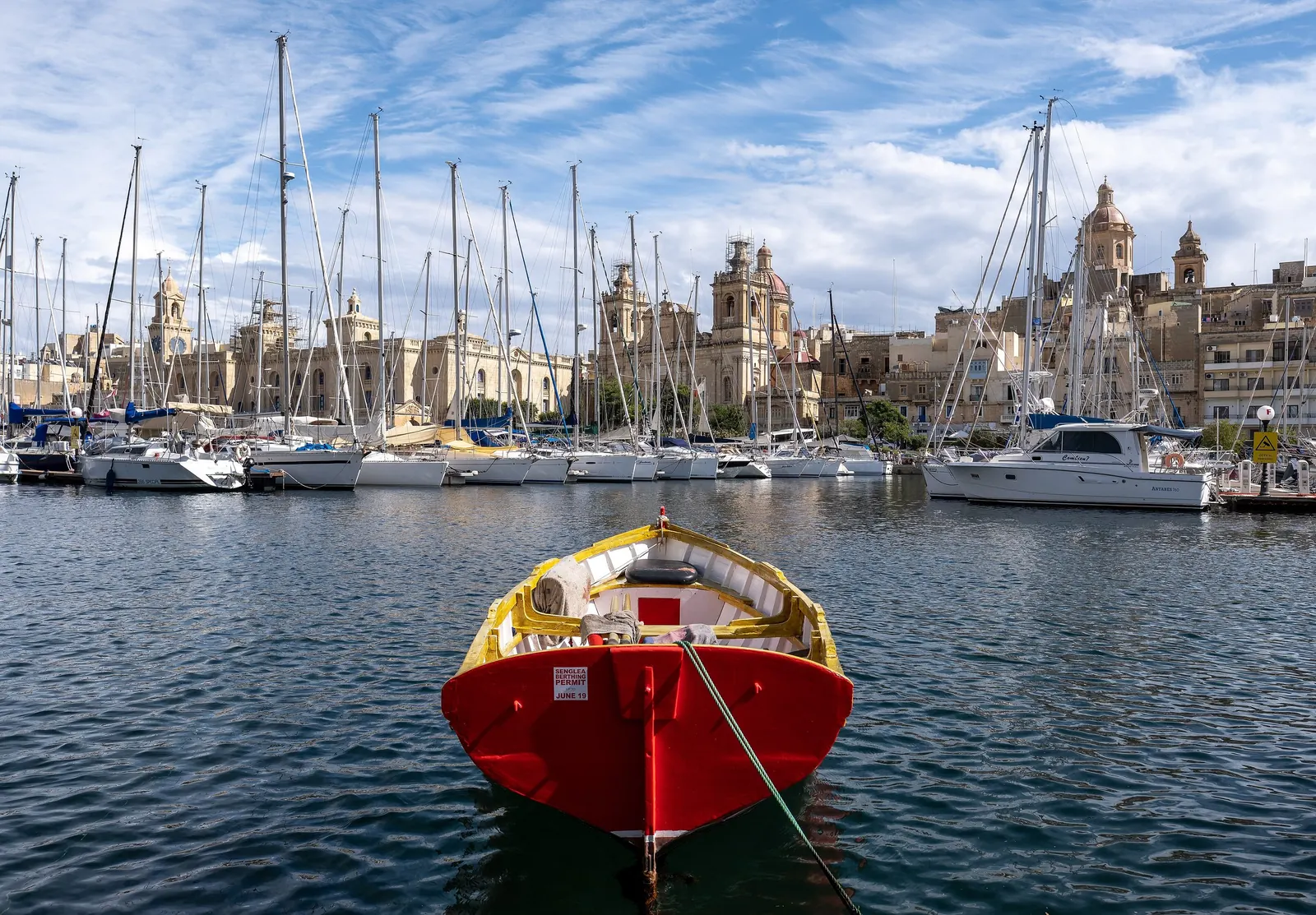A small boat on the Senglea waterfront, with Birgu behind