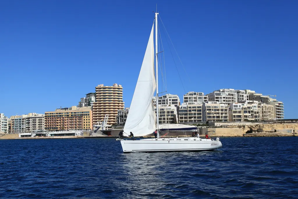 A yacht sailing past the Tigné Point seafront