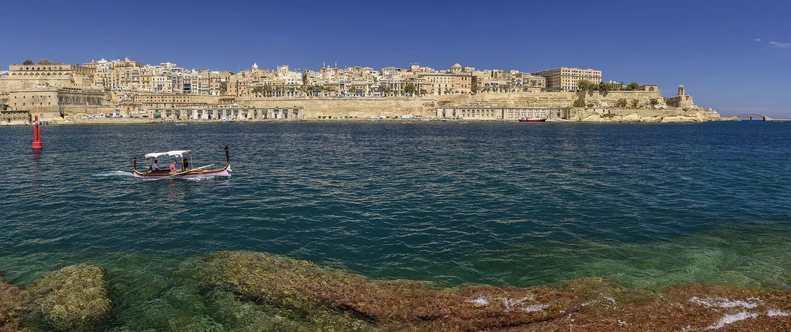 Valletta skyline seen from Birgu with a traditional luzzu