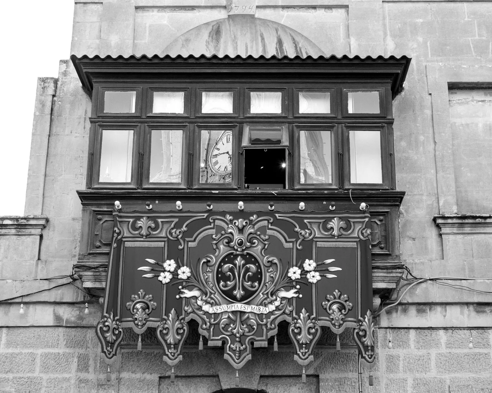 A Maltese balcony decorated for the village festa